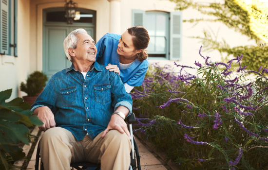 Cropped shot of a young female nurse outside with a senior patient in a wheelchair